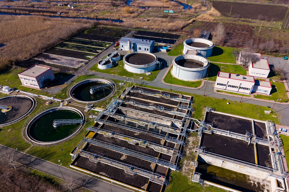 Aerial view of wastewater treatment facility with clarifiers and aeration systems