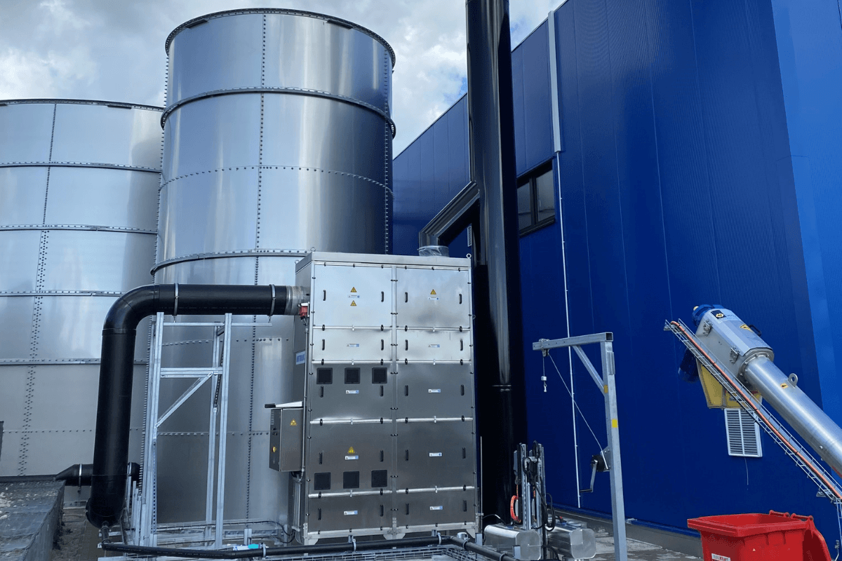Neutralox NX2000 odour control unit installed beside large storage tanks at a dairy processing facility in Germantown, Wisconsin.